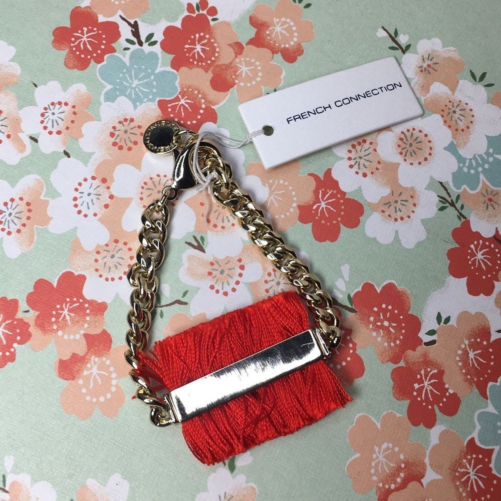 French Connection Gold Chain Link Bracelet with red string fringe statement